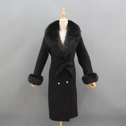 Black coat with fur trim on a mannequin against a gray background