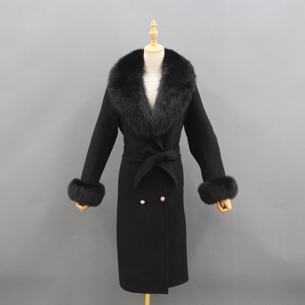 Black coat with fur trim on a mannequin against a gray background